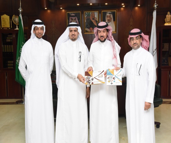 Honorable Rector of the University receives the Annual Report of the Deanship Graduate Studies